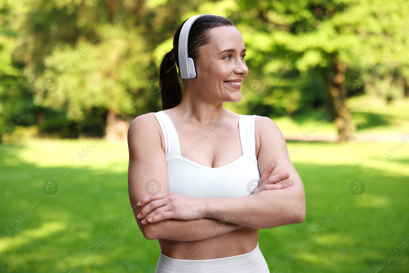 Photo of Woman in sportswear and headphones in park