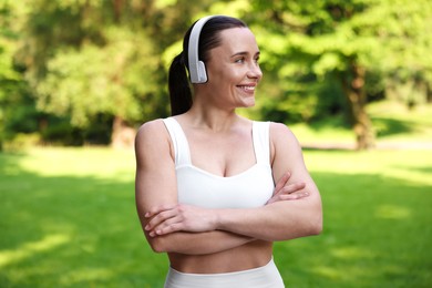 Photo of Woman in sportswear and headphones in park