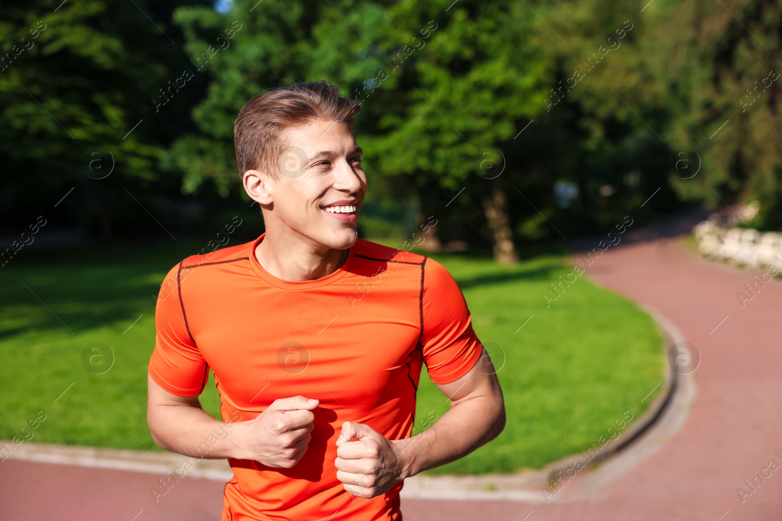 Photo of Sporty man running in park, space for text