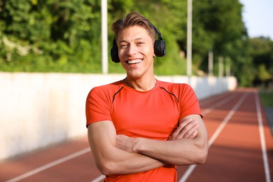 Photo of Sporty man with headphones at stadium. Healthy lifestyle