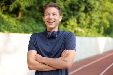 Photo of Portrait of sportsman with headphones at stadium