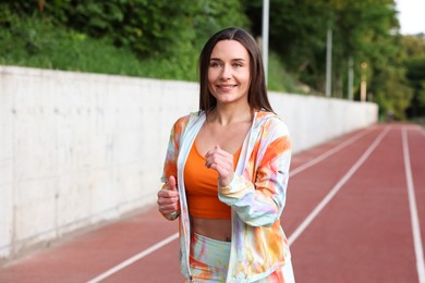 Photo of Sporty woman running at stadium. Healthy lifestyle