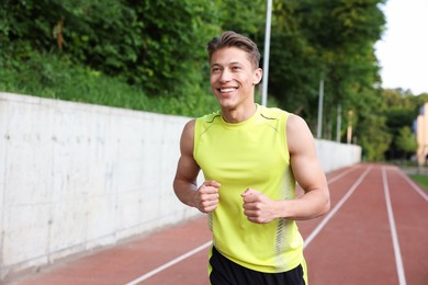Photo of Sporty man running at stadium. Healthy lifestyle