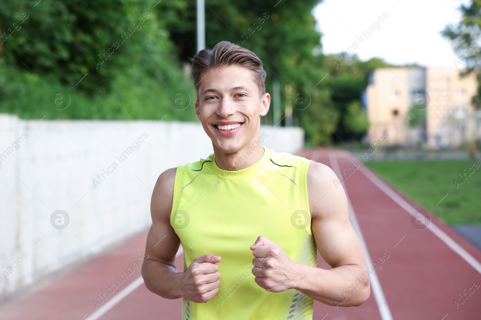 Photo of Sporty man running at stadium. Healthy lifestyle