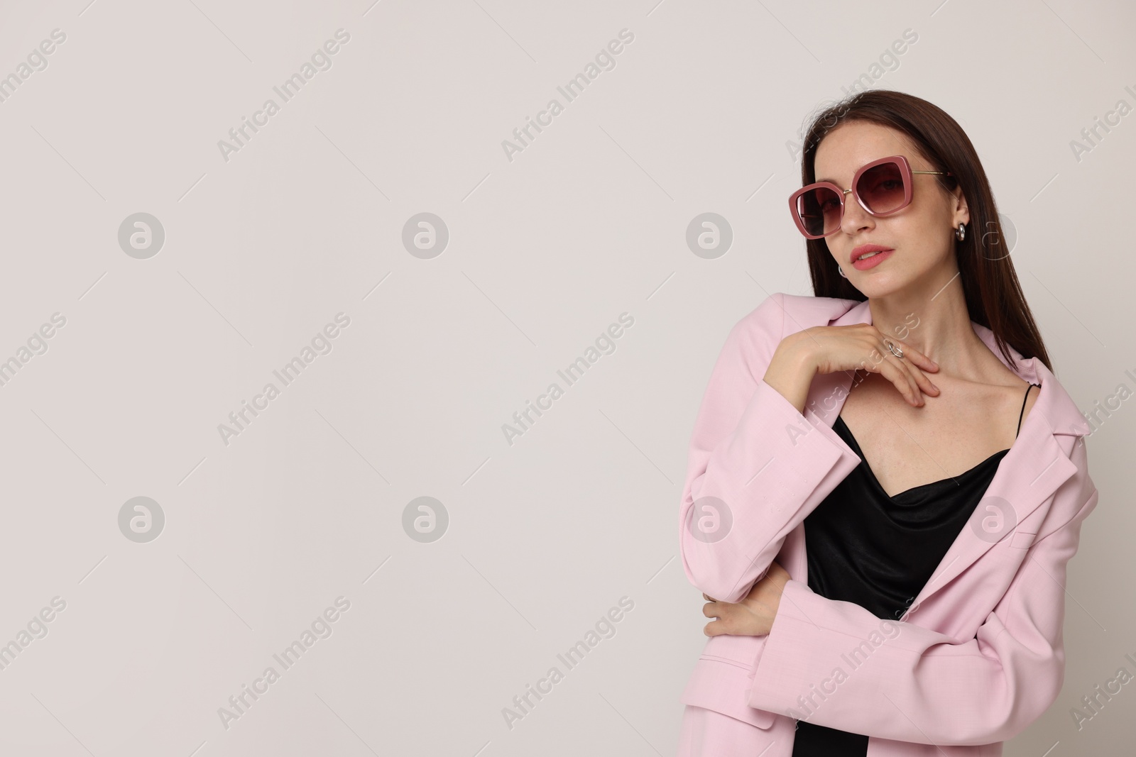 Photo of Portrait of beautiful woman in stylish outfit on white background, space for text