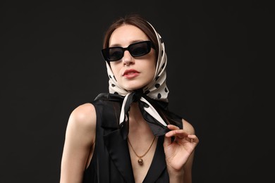 Photo of Beautiful woman in stylish outfit on black background