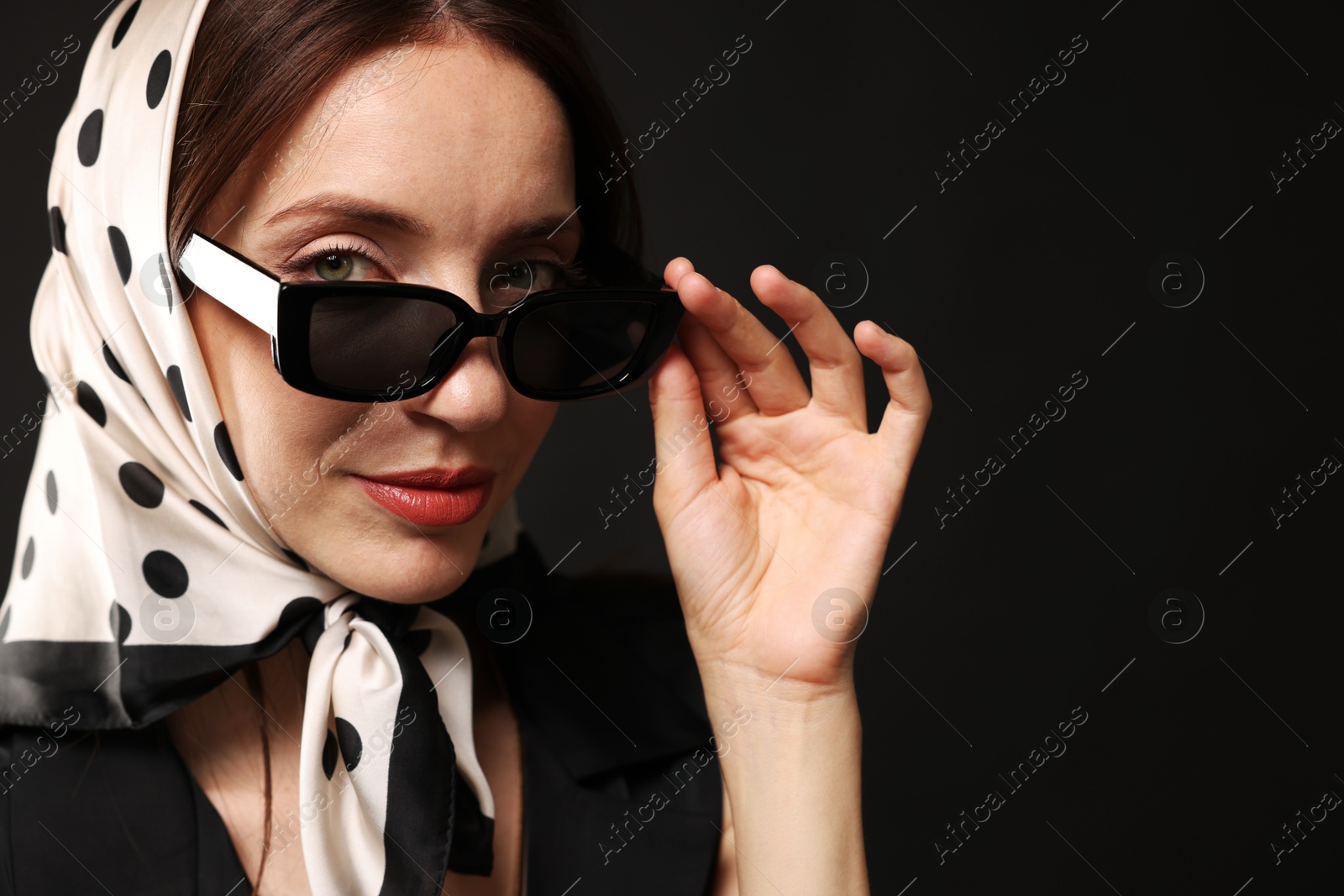 Photo of Beautiful woman in stylish outfit on black background. Space for text
