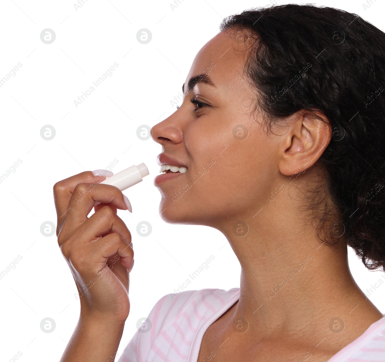 Smiling woman applying lip balm onto her lips on white background, closeup Photo of Smiling woman applying lip balm onto her lips on white background, closeup