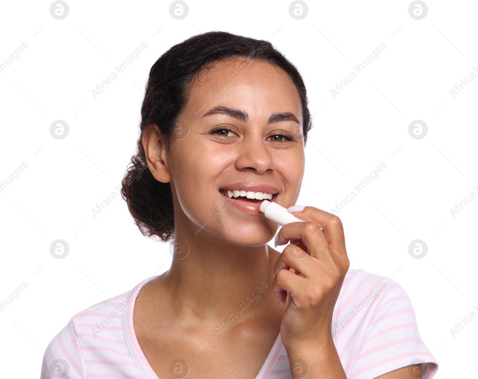 Photo of Smiling woman applying lip balm onto her lips on white background