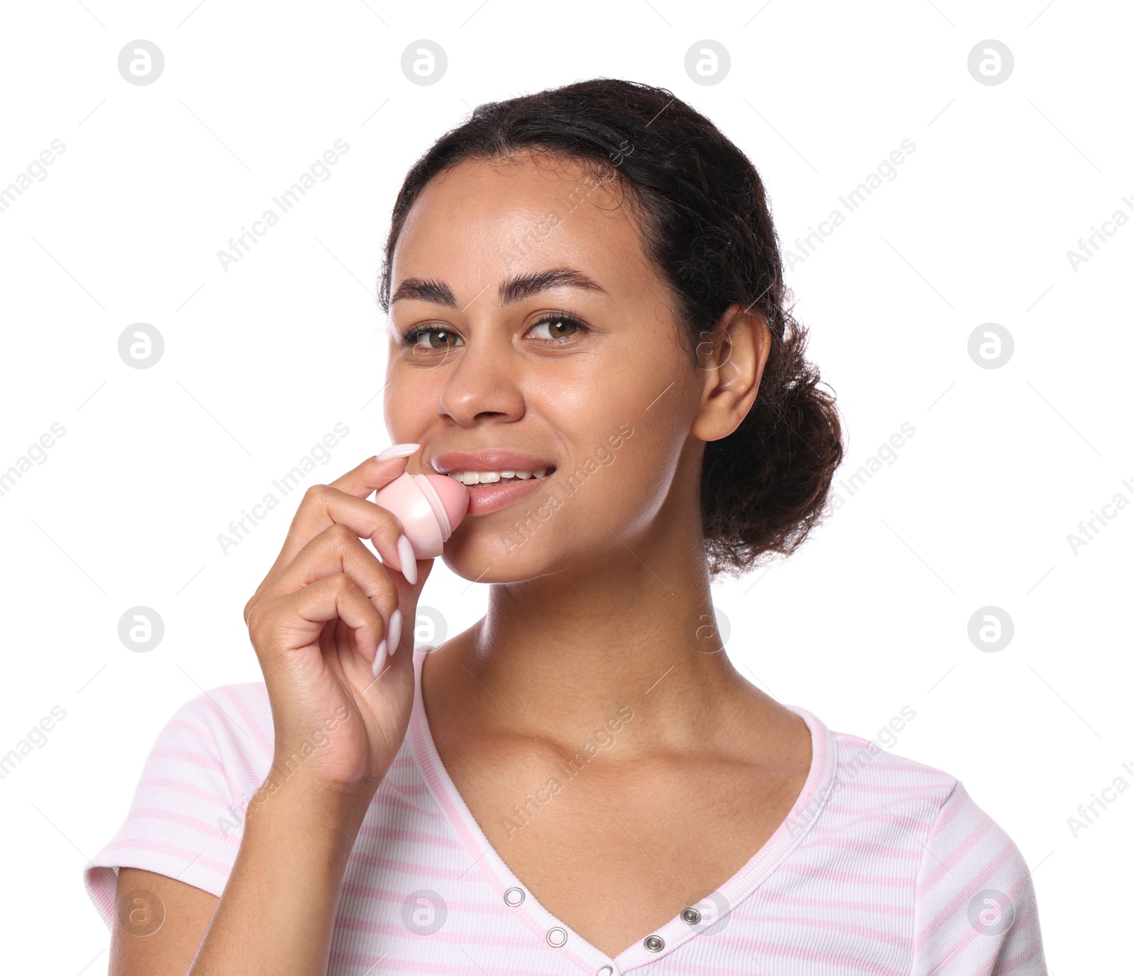 Smiling woman applying lip balm onto her lips on white background Photo of Smiling woman applying lip balm onto her lips on white background
