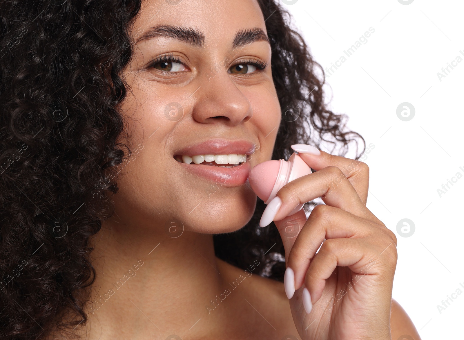 Smiling woman applying lip balm onto her lips on white background, closeup Photo of Smiling woman applying lip balm onto her lips on white background, closeup