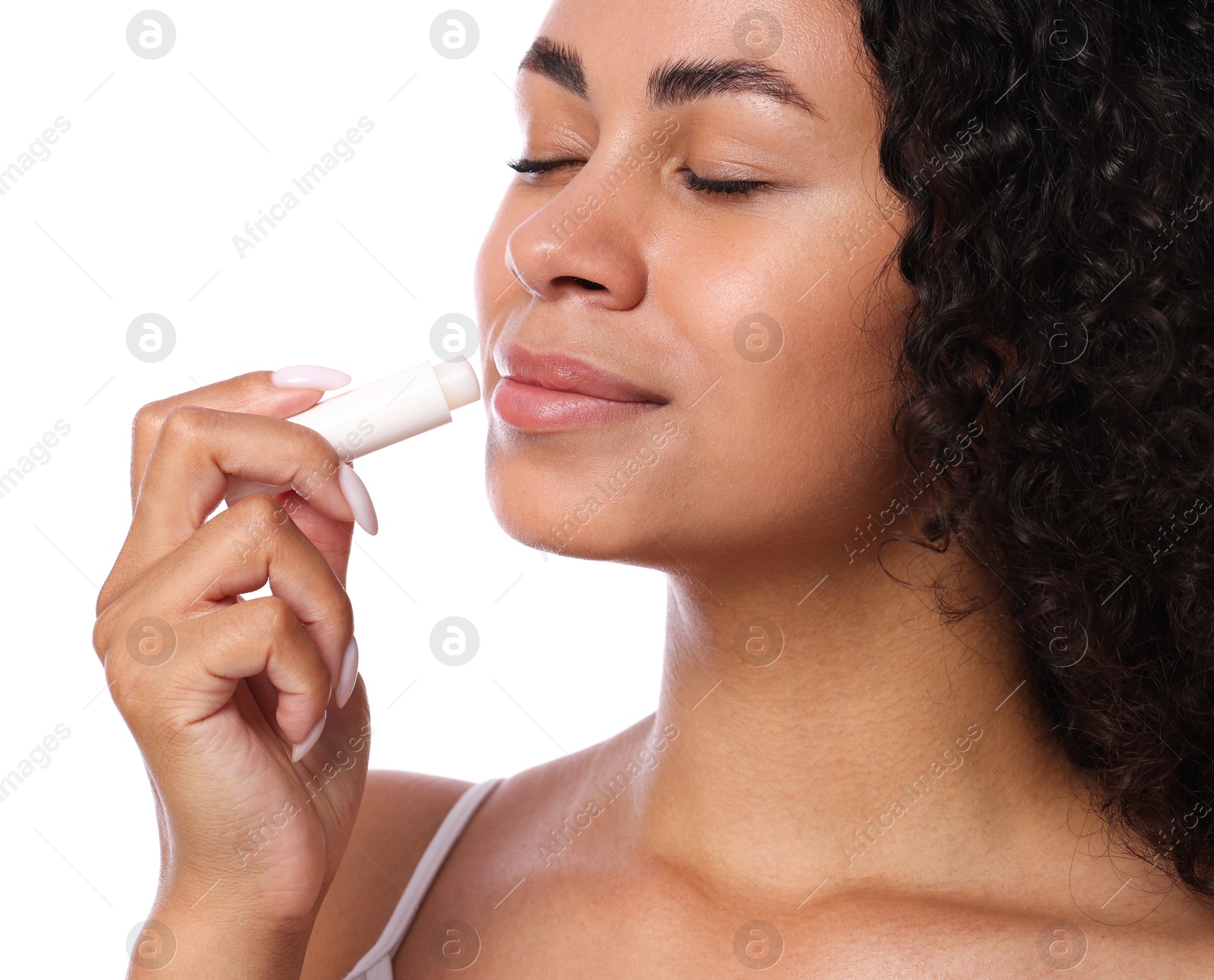 Photo of Beautiful woman applying lip balm onto her lips on white background, closeup