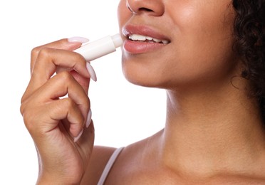 Photo of Smiling woman applying lip balm onto her lips on white background, closeup
