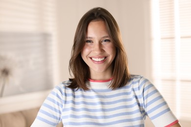 Photo of Portrait of smiling teenage girl at home