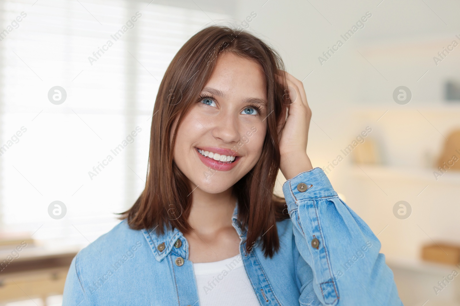 Portrait of smiling teenage girl at home Photo of Portrait of smiling teenage girl at home