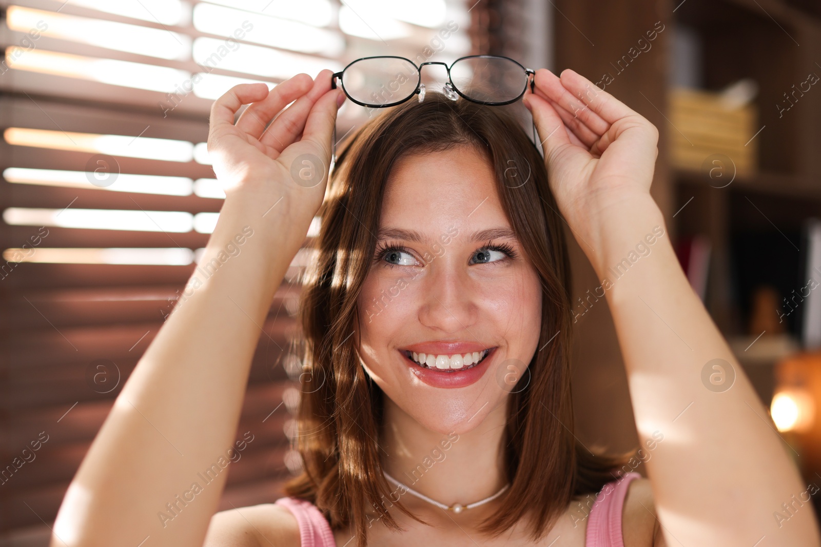 Smiling teenage girl with glasses at home Photo of Smiling teenage girl with glasses at home