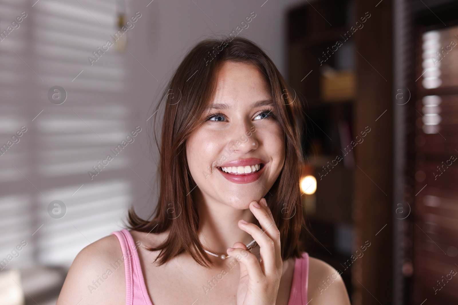 Portrait of smiling teenage girl at home Photo of Portrait of smiling teenage girl at home