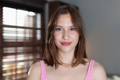 Photo of Portrait of beautiful teenage girl at home