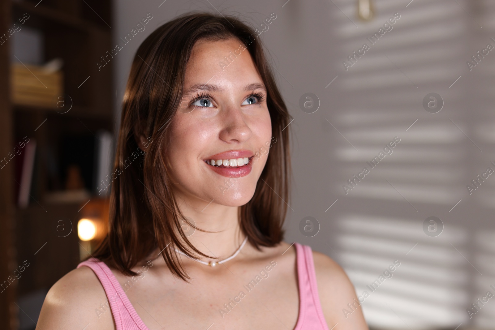 Portrait of smiling teenage girl at home Photo of Portrait of smiling teenage girl at home