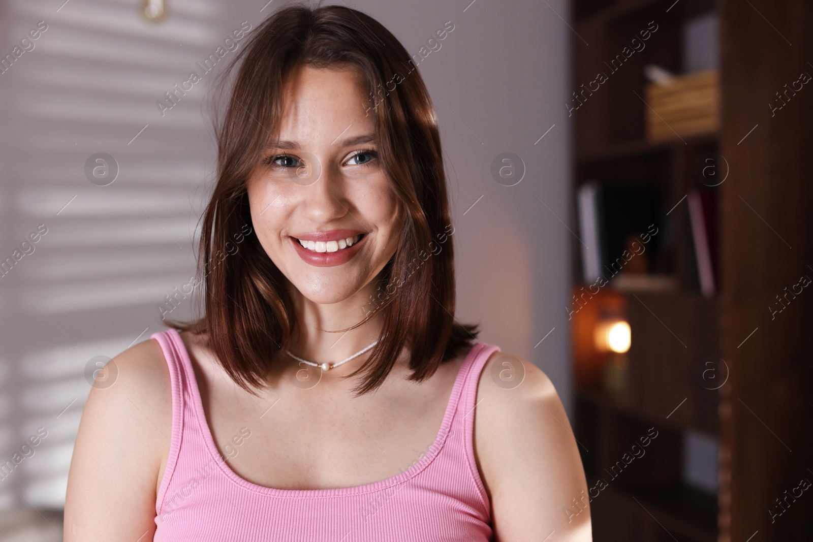 Portrait of smiling teenage girl at home Photo of Portrait of smiling teenage girl at home