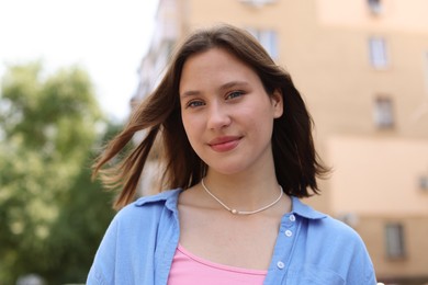 Photo of Portrait of beautiful teenage girl on city street