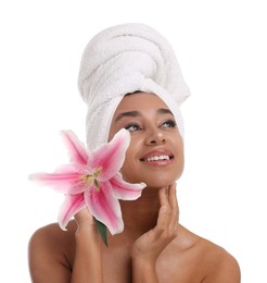 Photo of Portrait of beautiful Brazilian woman with lily flower after spa treatment on white background