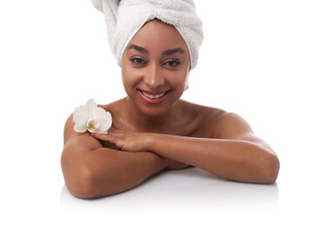 Photo of Portrait of beautiful Brazilian woman with orchid flower after spa treatment on white background