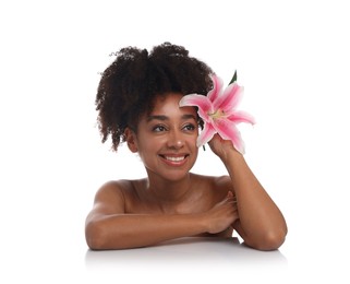 Photo of Portrait of beautiful Brazilian woman with lily flower after spa treatment on white background