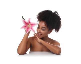 Photo of Portrait of beautiful Brazilian woman with lily flower after spa treatment on white background