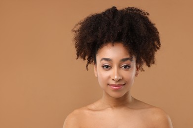 Photo of Portrait of beautiful Brazilian woman after spa treatment on light brown background. Space for text