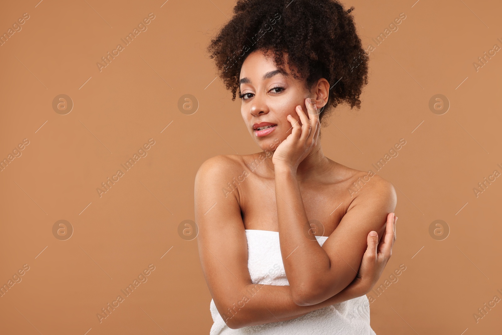Photo of Portrait of beautiful Brazilian woman after spa treatment on light brown background. Space for text