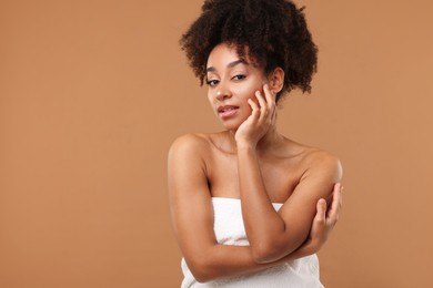 Photo of Portrait of beautiful Brazilian woman after spa treatment on light brown background. Space for text