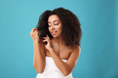Photo of Portrait of beautiful Brazilian woman after spa treatment on light blue background
