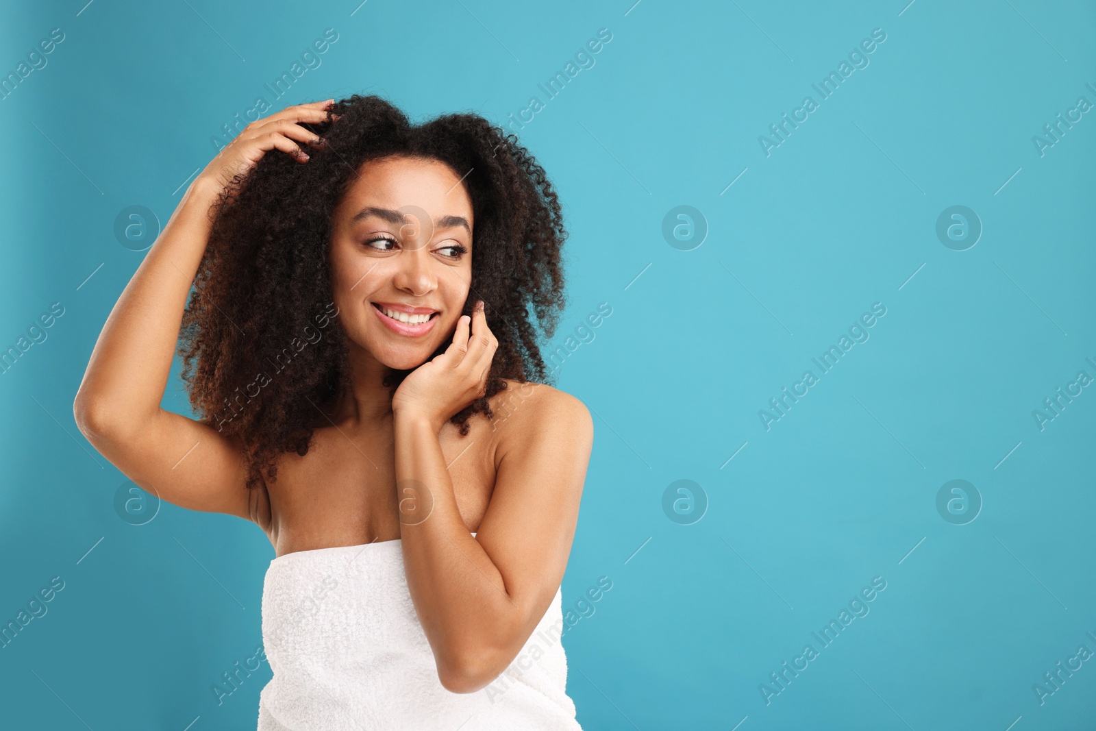 Photo of Portrait of beautiful Brazilian woman after spa treatment on light blue background. Space for text