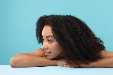 Photo of Portrait of beautiful Brazilian woman after spa treatment on light blue background