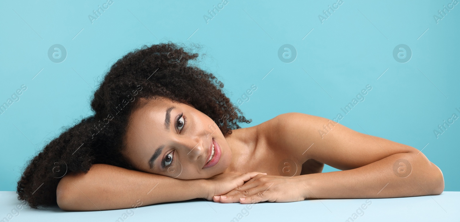 Portrait of beautiful Brazilian woman after spa treatment on light blue background Photo of Portrait of beautiful Brazilian woman after spa treatment on light blue background