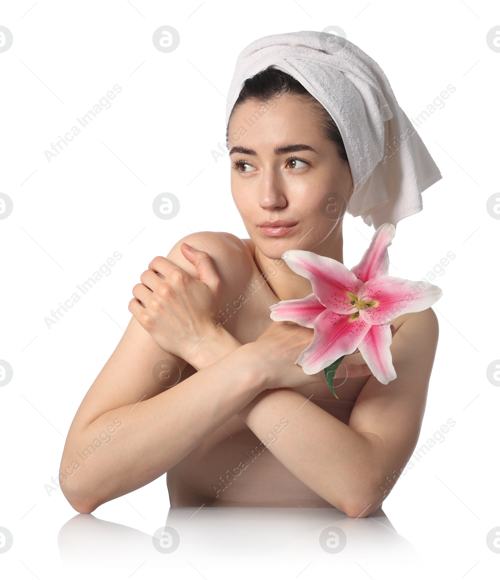 Beautiful woman with lily flower after spa treatment at mirror surface on white background Photo of Beautiful woman with lily flower after spa treatment at mirror surface on white background