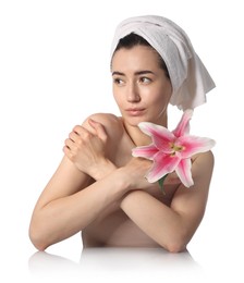 Photo of Beautiful woman with lily flower after spa treatment at mirror surface on white background