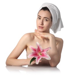 Photo of Portrait of beautiful woman with lily flower after spa treatment at mirror surface on white background
