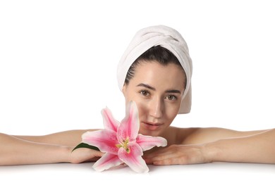 Photo of Portrait of beautiful woman with lily flower after spa treatment at mirror surface on white background