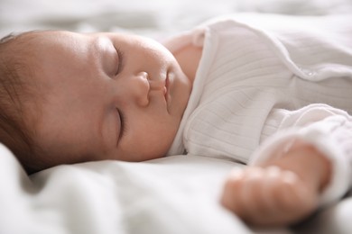 Photo of Cute newborn baby sleeping on bed, closeup