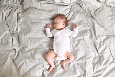 Photo of Cute newborn baby sleeping on bed, top view