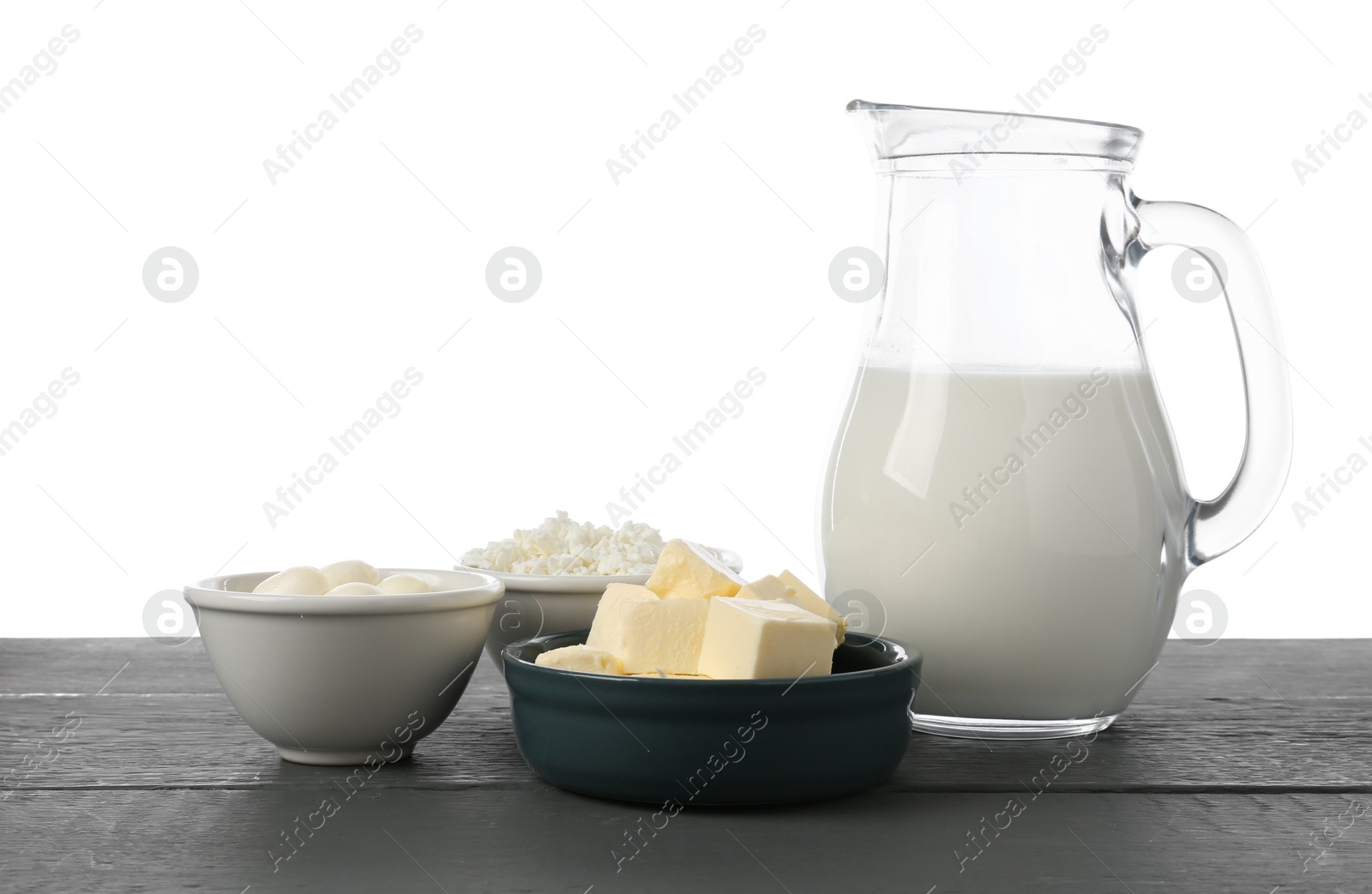 Different dairy products on grey wooden table against white background Photo of Different dairy products on grey wooden table against white background