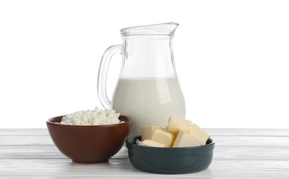 Photo of Different dairy products on wooden table against white background