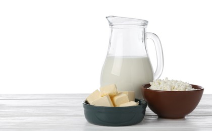 Photo of Different dairy products on wooden table against white background