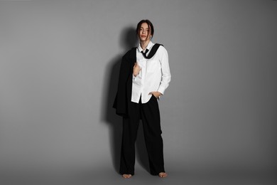 Photo of Full-length portrait of beautiful woman in stylish outfit on light grey background