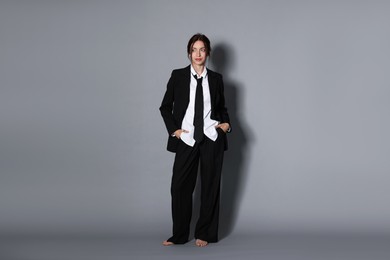 Photo of Full-length portrait of beautiful woman in stylish outfit on light grey background