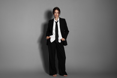 Photo of Full-length portrait of beautiful woman in stylish outfit on light grey background