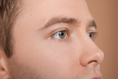 Photo of Handsome man on beige background, closeup view
