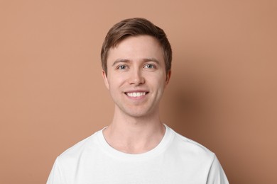 Photo of Handsome man after shaving on beige background